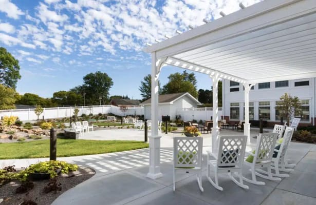 Outdoor seating area with rocking chairs and scenic view
