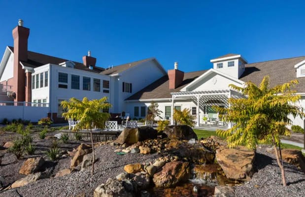 Exterior view of a senior living facility with outdoor space
