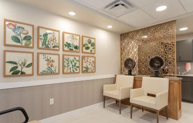 Framed botanical art on lobby wall with seating area