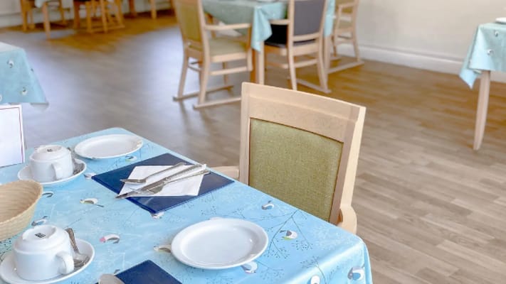 Dining area with a set table and chairs