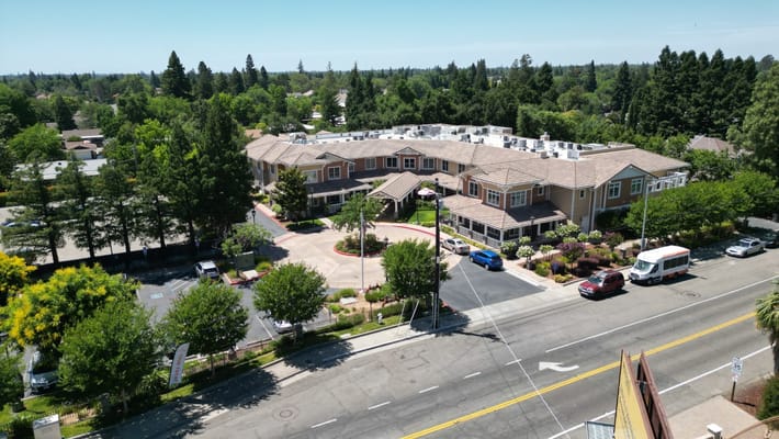 Aerial view of Sunrise of Carmichael senior living facility surrounded by greenery.