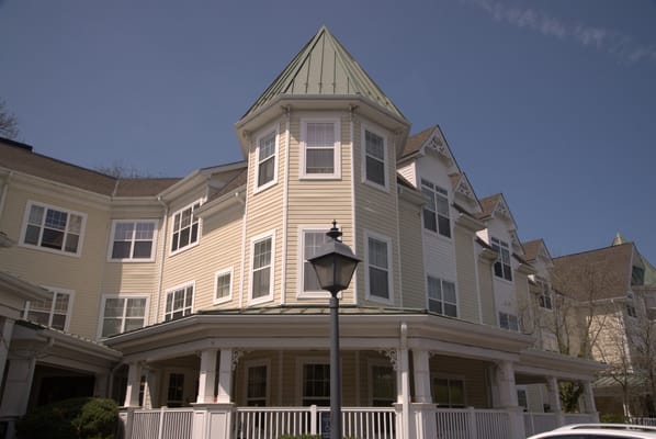 The exterior of Sunrise of Haverford featuring a peaked roof and porch area.