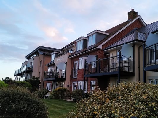 Building facade of Dean Lodge with balconies and landscaped garden