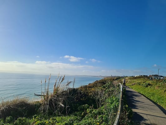 View of a coastal path with sea and sky