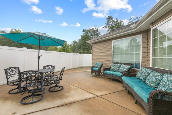 Outdoor seating area with turquoise cushions and table