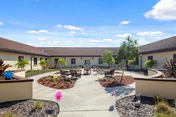 A bright outdoor courtyard with seating and landscaping