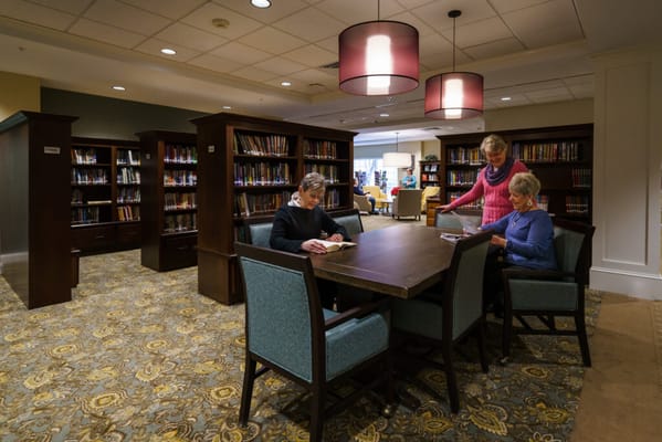 Residents enjoying a cozy library reading area