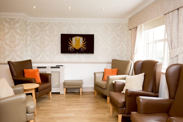 Cozy lounge area with comfortable seating and a television