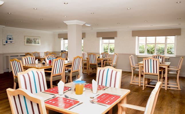 Quiet dining room with neatly set tables and chairs