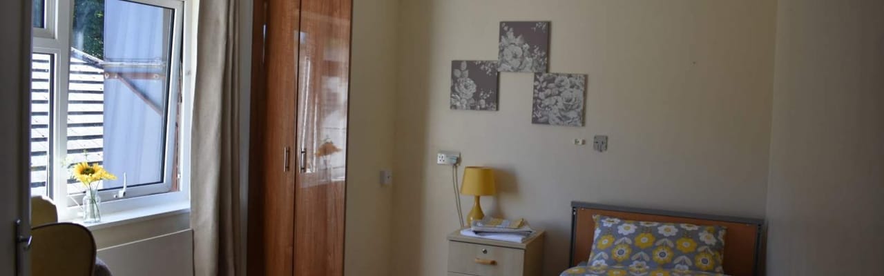 Private resident room with yellow decor and flowers