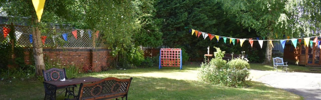Outdoor garden area with colorful bunting and seating