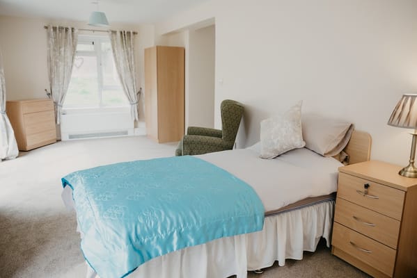 Cozy private resident room with a bed and furniture