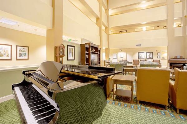 Interior view of a community lounge with a piano