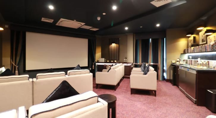 Interior of a cozy multimedia room with seating.