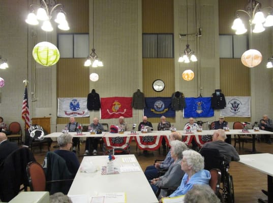 Veterans seated at a table during a gathering at Evergreen in Dickinson.