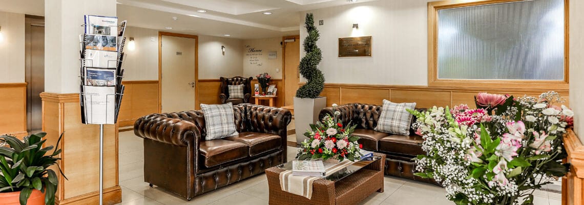 A cozy lounge area with comfortable seating and flowers