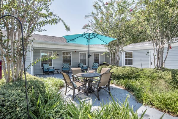 Outdoor seating area with patio furniture and landscaping