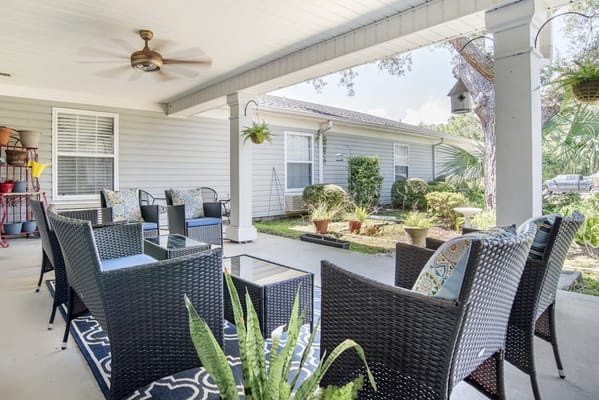 Outdoor seating area with wicker chairs and plants