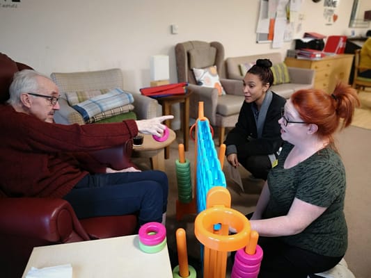 Residents and staff engaged in a game activity.