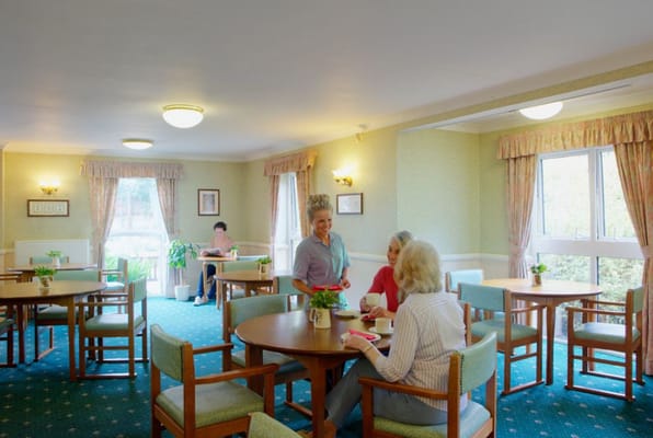 Residents enjoying a conversation in the lounge of Ferguson Lodge.