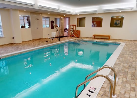 Indoor swimming pool area with bright lighting