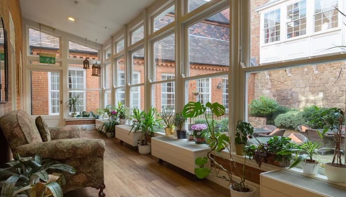 Bright sunroom with seating and plants