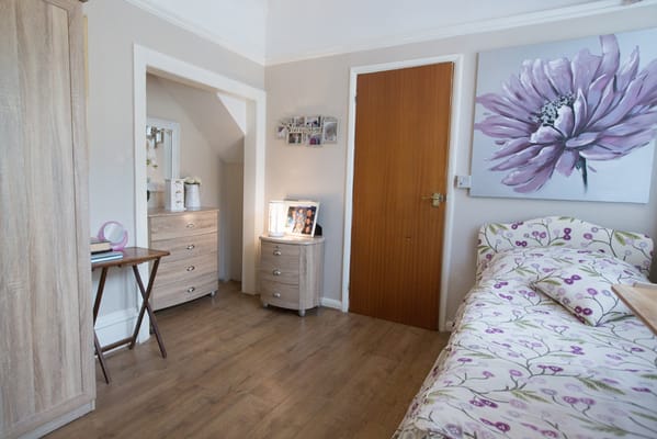 Cozy private room with floral bedding and decor