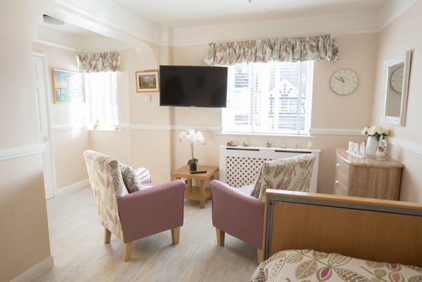 Bright interior of a resident room with seating area