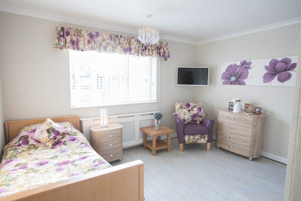 Cozy resident room with floral decor and furnishings