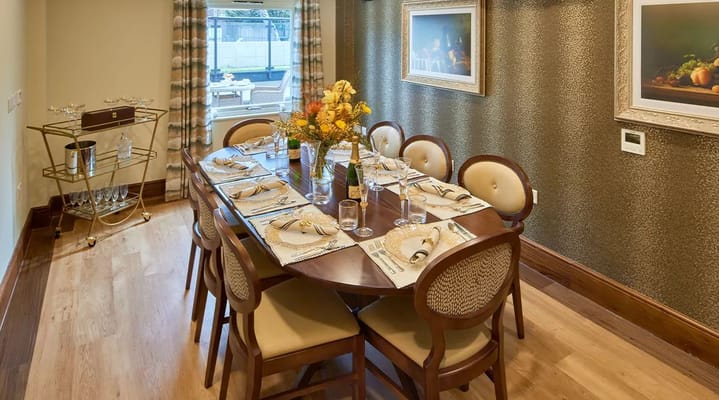 Elegant dining room setup with a wooden table and floral centerpiece