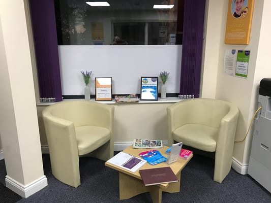Interior view of a common area with seating and brochures