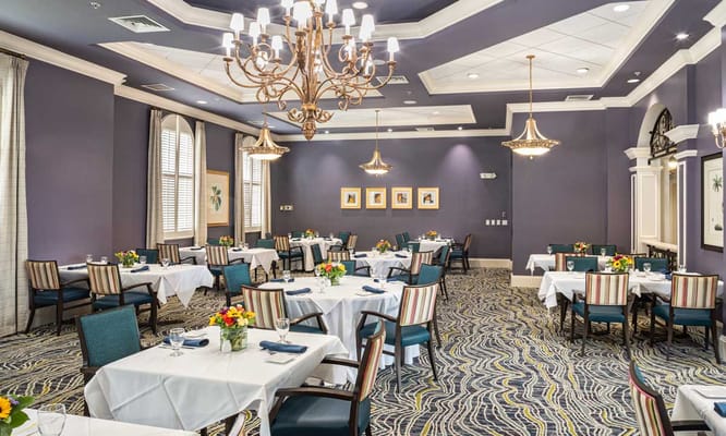 Elegant dining room with tables set for meals