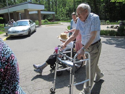 Residents enjoying a stroll outdoors in the facility grounds