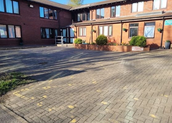 Exterior view of Hurstway Care Home's entrance and parking area