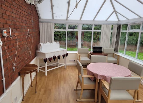 Bright common area with seating and a dining table