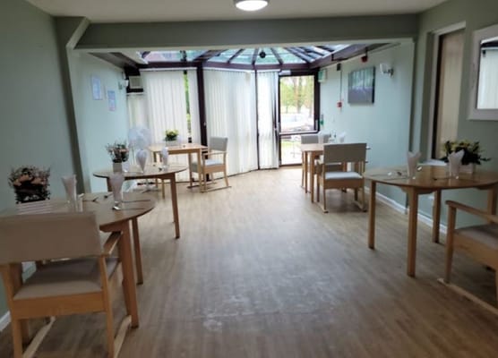 Dining area with tables set for residents