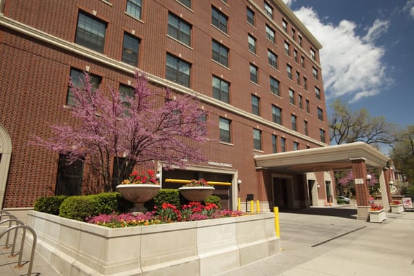 Exterior view of Belmont Village Senior Living with flowers