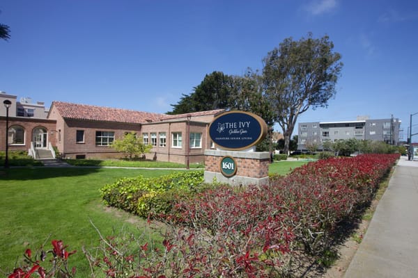 The Ivy at Golden Gate sign and building outside with landscaped garden.