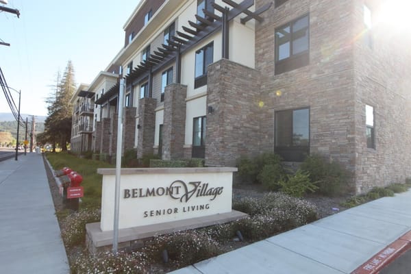 Exterior of Belmont Village Senior Living building with signage
