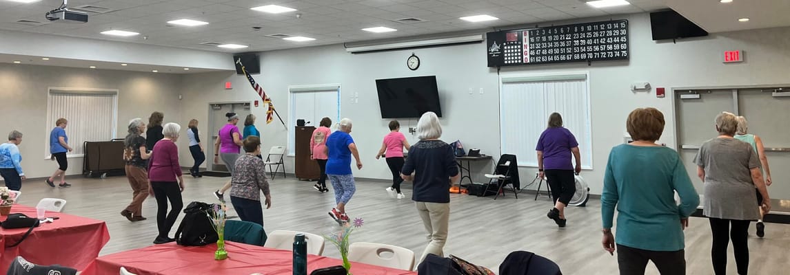 Residents participating in an exercise class in the activity room