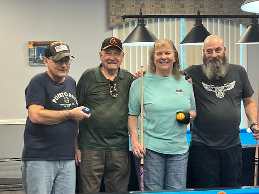 Residents and staff enjoying a game of billiards