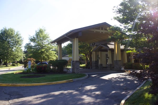 Entrance area of Sunrise at Bon Air senior living facility with a covered walkway