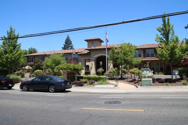 Exterior view of Oakmont of Carmichael with landscaped entrance