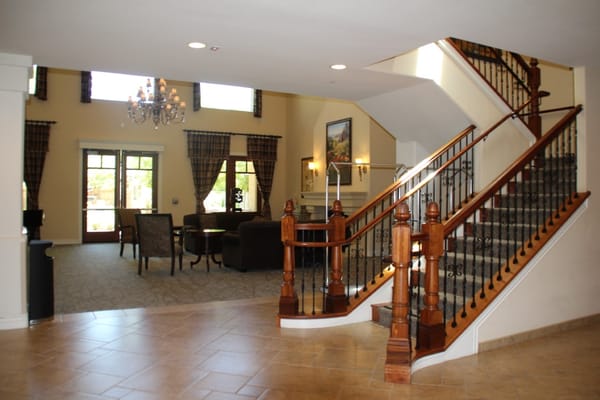 Bright lobby area with stairway and seating