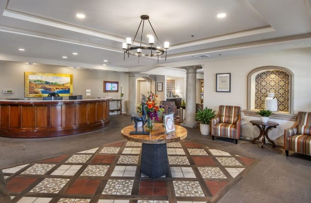 Lobby area featuring a reception desk, decorative seating, and colorful artwork.