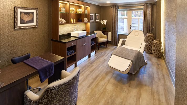 Spa treatment room with a reclining chair and natural decor