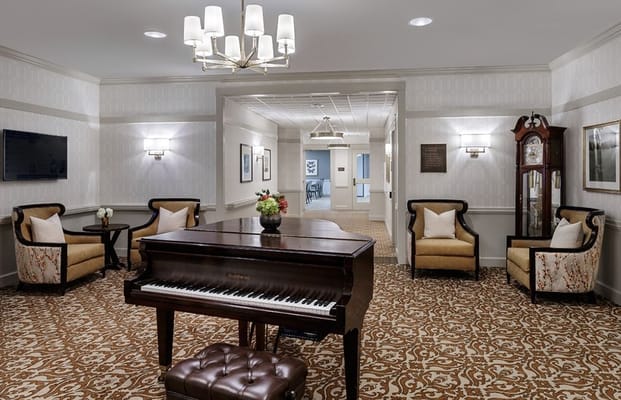 Lobby area featuring a grand piano and comfortable seating.