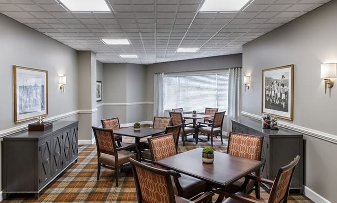Bright common area with wooden tables and chairs