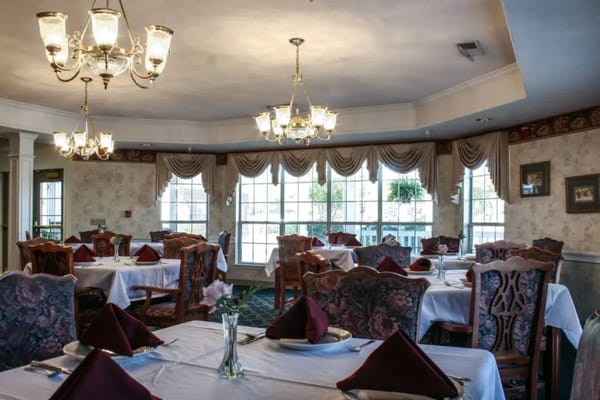 Elegant dining room with tables set for meals