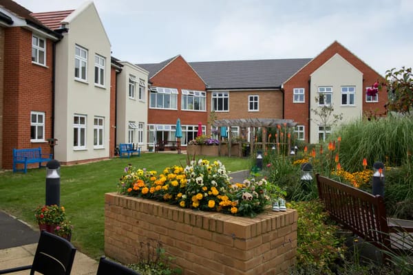 Garden area with flowers and seating at a senior living facility